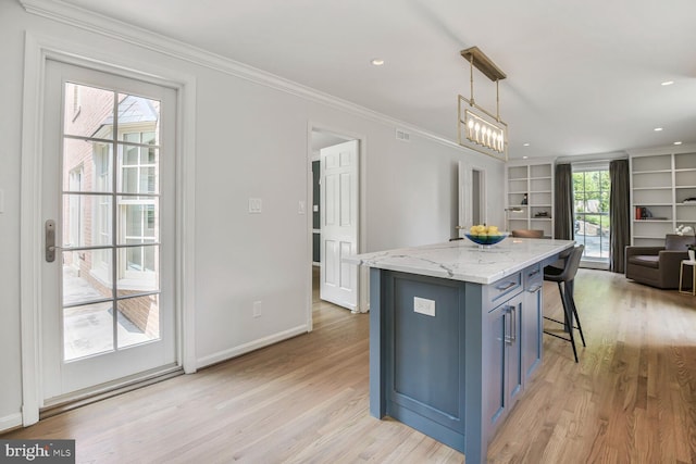 4701 Fort Sumner Dr, Bethesda, MD 20816 - kitchen with a kitchen breakfast bar, light wood finished floors, a center island, pendant lighting, and ornamental molding