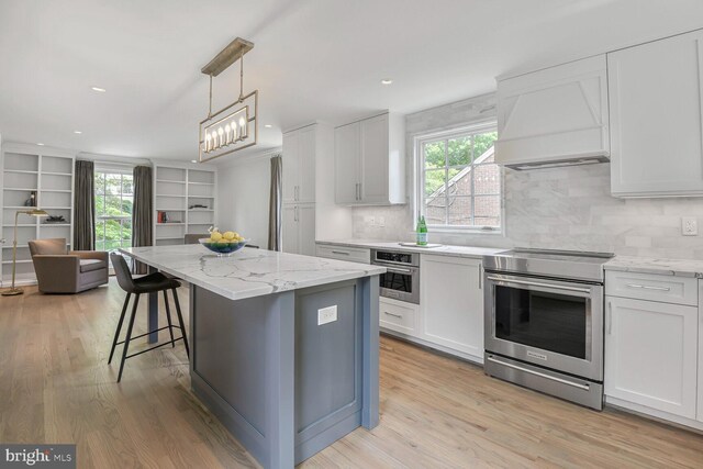 4701 Fort Sumner Dr, Bethesda, MD 20816 - kitchen featuring stainless steel appliances, light wood-style floors, light stone counters, tasteful backsplash, and recessed lighting