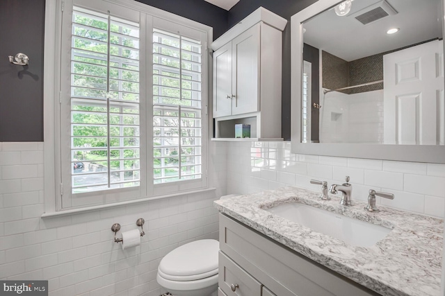 4701 Fort Sumner Dr, Bethesda, MD 20816 - bathroom with toilet, vanity, tile walls, a tile shower, and decorative backsplash