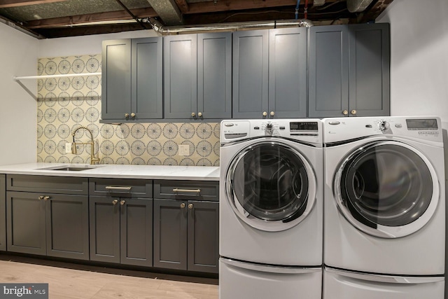 4701 Fort Sumner Dr, Bethesda, MD 20816 - laundry room with cabinet space, washing machine and clothes dryer, and light wood-style flooring