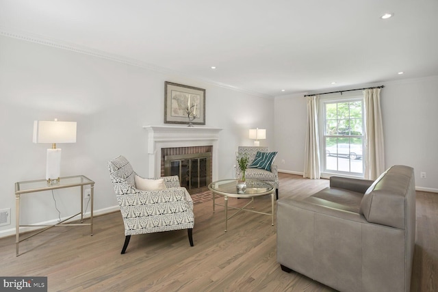 4701 Fort Sumner Dr, Bethesda, MD 20816 - living area featuring ornamental molding, wood finished floors, a brick fireplace, baseboards, and recessed lighting