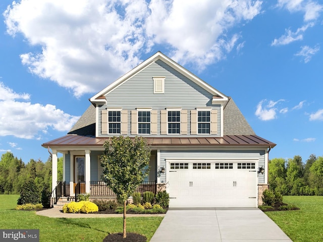 view of front of property featuring a standing seam roof, driveway, a front lawn, a porch, and metal roof
