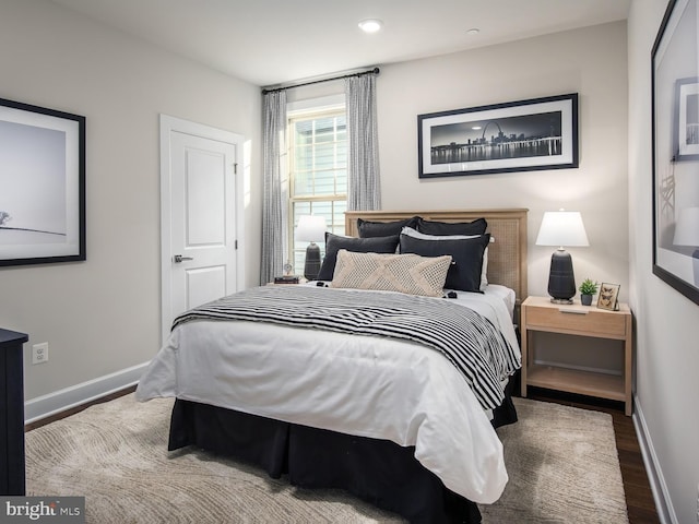bedroom with wood finished floors, baseboards, and recessed lighting