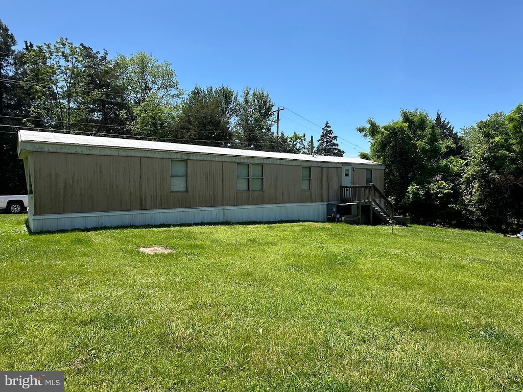 rear view of property featuring a yard