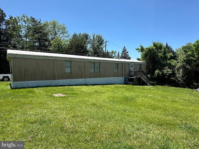 rear view of property featuring a yard