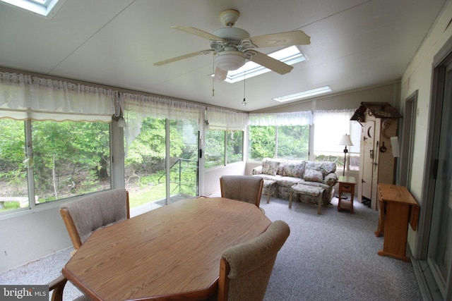 sunroom with a skylight, a ceiling fan, healthy amount of natural light, and lofted ceiling
