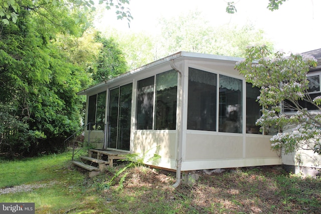 view of side of home with a sunroom
