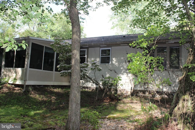 rear view of house with a sunroom