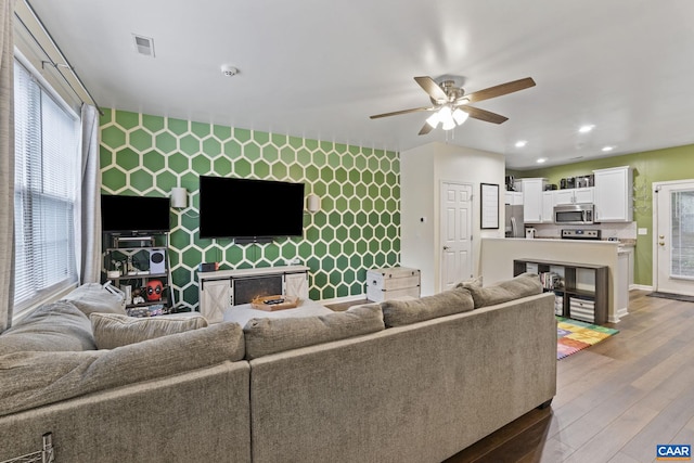 1731 Webland Park, Charlottesville, VA 22901 - living room with an accent wall, ceiling fan, wood finished floors, recessed lighting, and baseboards
