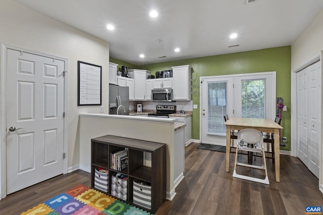 1731 Webland Park, Charlottesville, VA 22901 - kitchen with stainless steel appliances, light countertops, a peninsula, dark wood-style floors, and white cabinetry