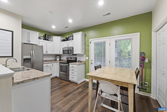 1731 Webland Park, Charlottesville, VA 22901 - kitchen with appliances with stainless steel finishes, dark wood-style floors, a sink, white cabinetry, and recessed lighting