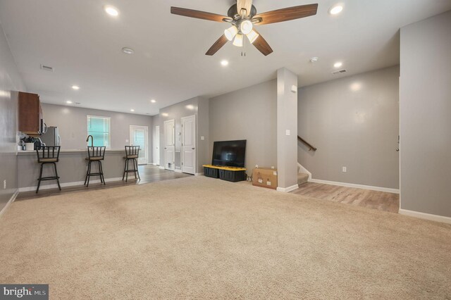 45 Quigley Ct, Camden Wyoming, DE 19934 - living room with light colored carpet, stairs, recessed lighting, a ceiling fan, and baseboards