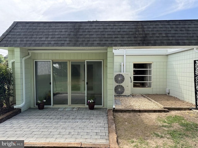 195 S Dr Unit E6, Kilmarnock, VA 22482 - rear view of property featuring roof with shingles, mansard roof, a patio, and ac unit
