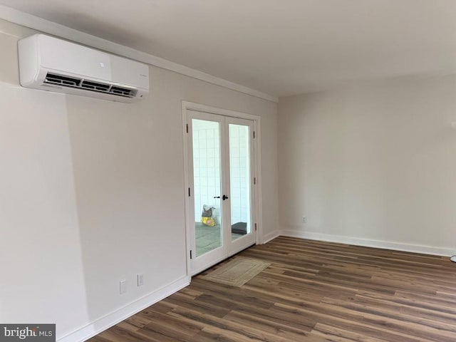 195 S Dr Unit E6, Kilmarnock, VA 22482 - unfurnished room with an AC wall unit, wood finished floors, baseboards, and french doors