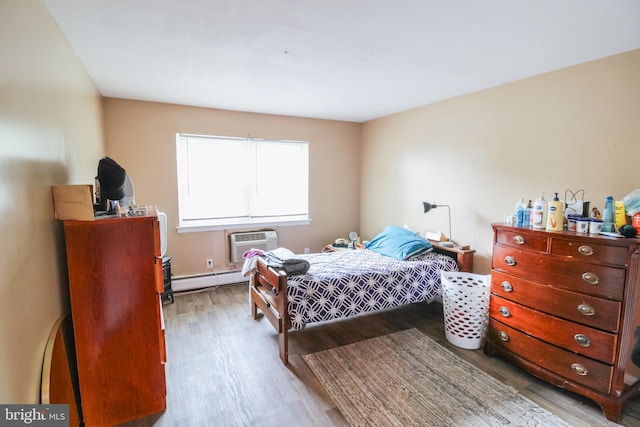 415 Garnet Dr, Burlington, NJ 08016 - bedroom with wood finished floors, a wall mounted air conditioner, and a baseboard radiator
