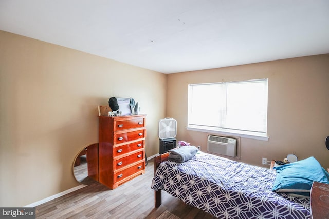 415 Garnet Dr, Burlington, NJ 08016 - bedroom featuring wood finished floors, a wall mounted air conditioner, and baseboards