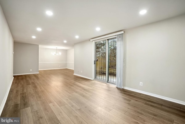 1900 Lyttonsville Rd Unit 216, Silver Spring, MD 20910 - spare room featuring a chandelier, recessed lighting, baseboards, and wood finished floors