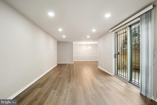 1900 Lyttonsville Rd Unit 216, Silver Spring, MD 20910 - unfurnished room with wood finished floors, a chandelier, baseboards, and recessed lighting