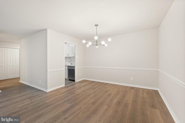 1900 Lyttonsville Rd Unit 216, Silver Spring, MD 20910 - unfurnished dining area with wood finished floors, a chandelier, and baseboards