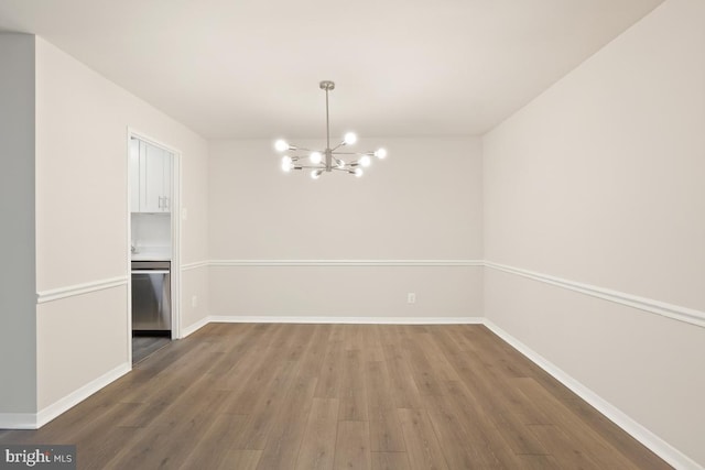 1900 Lyttonsville Rd Unit 216, Silver Spring, MD 20910 - unfurnished dining area with wood finished floors, a chandelier, and baseboards