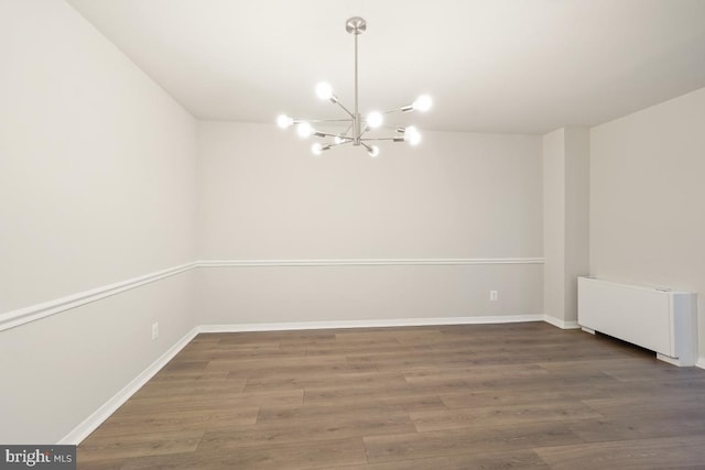 1900 Lyttonsville Rd Unit 216, Silver Spring, MD 20910 - unfurnished dining area with radiator, a chandelier, wood finished floors, and baseboards