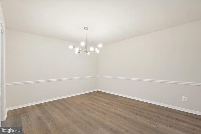 1900 Lyttonsville Rd Unit 216, Silver Spring, MD 20910 - empty room featuring a chandelier, dark wood-style flooring, and baseboards