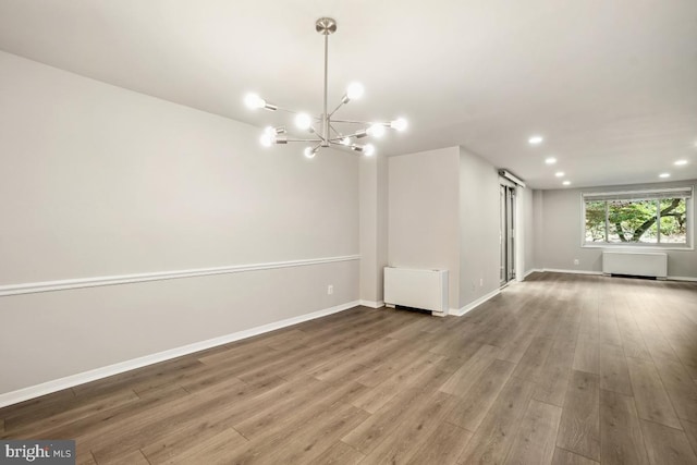 1900 Lyttonsville Rd Unit 216, Silver Spring, MD 20910 - empty room with radiator heating unit, wood finished floors, recessed lighting, baseboards, and a chandelier