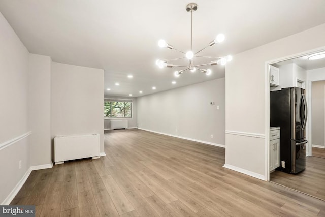 1900 Lyttonsville Rd Unit 216, Silver Spring, MD 20910 - empty room with radiator heating unit, a chandelier, light wood-style floors, baseboards, and recessed lighting