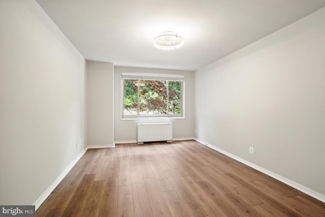 1900 Lyttonsville Rd Unit 216, Silver Spring, MD 20910 - empty room with radiator, baseboards, and wood finished floors
