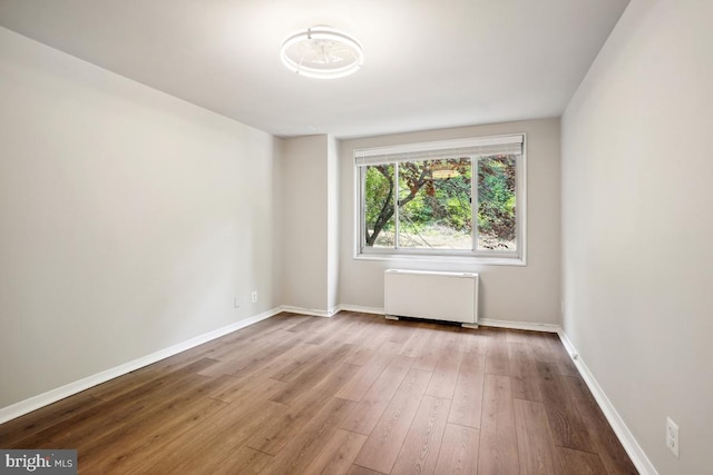 1900 Lyttonsville Rd Unit 216, Silver Spring, MD 20910 - unfurnished room with radiator heating unit, wood finished floors, and baseboards