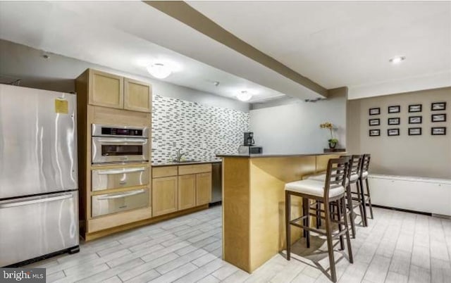 1900 Lyttonsville Rd Unit 216, Silver Spring, MD 20910 - kitchen featuring stainless steel appliances, a warming drawer, a breakfast bar, and a sink