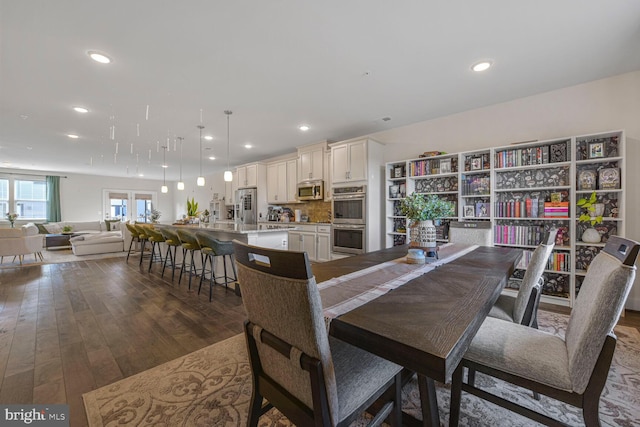 dining space featuring dark wood finished floors and recessed lighting