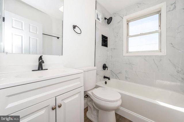 bathroom featuring toilet, vanity, and shower / tub combination