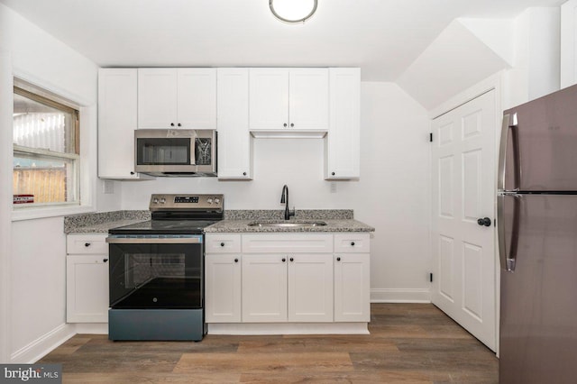 kitchen with appliances with stainless steel finishes, a sink, and white cabinets