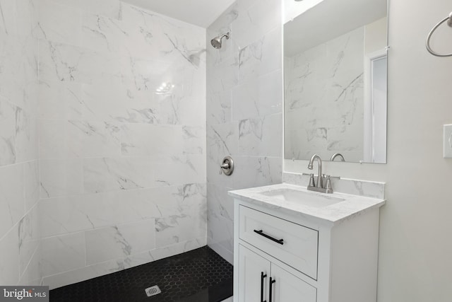 bathroom with a shower stall and vanity