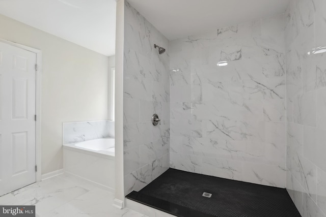bathroom featuring marble look tiles, a stall shower, and a garden tub