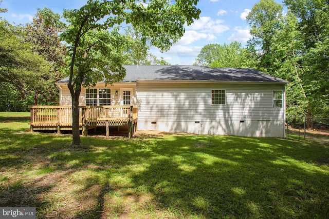back of house featuring crawl space, a deck, and a yard