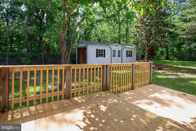 wooden deck with an outdoor structure and view of scattered trees
