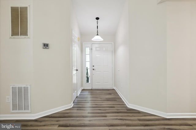 entryway featuring dark wood-style floors and baseboards