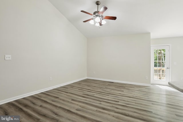 unfurnished room featuring lofted ceiling, wood finished floors, a ceiling fan, and baseboards