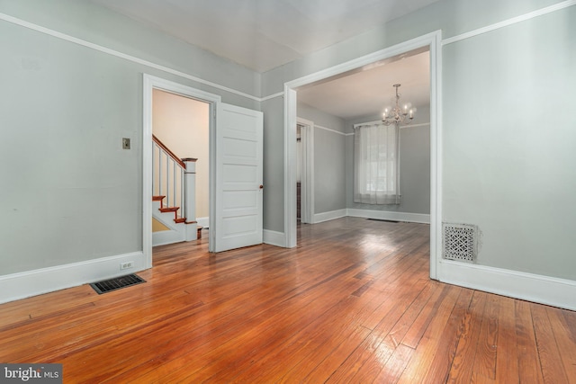 116 Price St, West Chester, PA 19382 - empty room with a chandelier, hardwood / wood-style floors, stairs, and baseboards