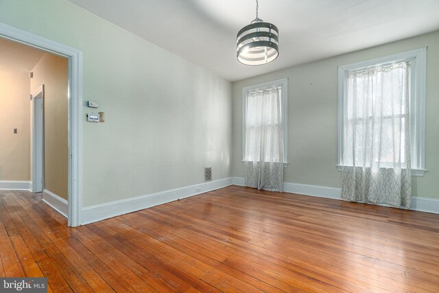 116 Price St, West Chester, PA 19382 - spare room featuring wood-type flooring, healthy amount of natural light, and a chandelier