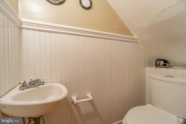 116 Price St, West Chester, PA 19382 - bathroom featuring vaulted ceiling, a sink, toilet, and wood walls