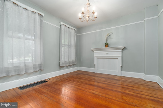 116 Price St, West Chester, PA 19382 - unfurnished dining area with a chandelier, hardwood / wood-style floors, and baseboards