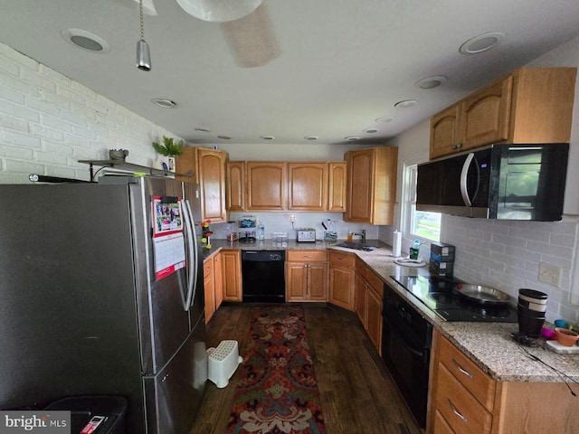 33 Middlebury Ln, Willingboro, NJ 08046 - kitchen with black appliances, dark wood-style flooring, tasteful backsplash, light stone counters, and a sink