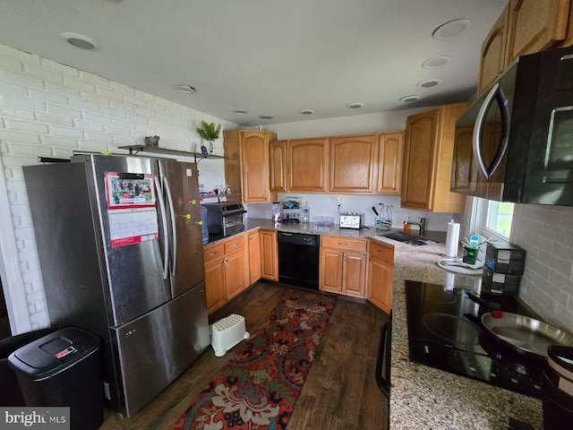 33 Middlebury Ln, Willingboro, NJ 08046 - kitchen with black appliances, dark wood finished floors, a sink, light stone counters, and brown cabinetry