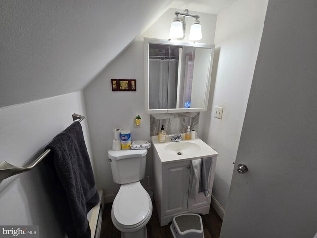 33 Middlebury Ln, Willingboro, NJ 08046 - bathroom with vanity, lofted ceiling, toilet, and wood finished floors