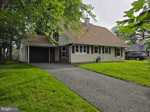 33 Middlebury Ln, Willingboro, NJ 08046 - view of front of home featuring a garage, a front lawn, driveway, and a chimney