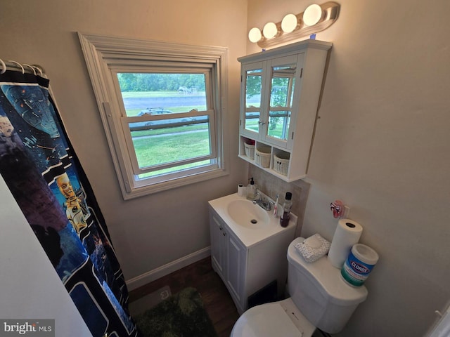 33 Middlebury Ln, Willingboro, NJ 08046 - bathroom with vanity, toilet, wood finished floors, and baseboards