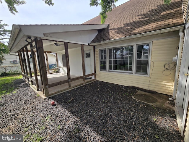 33 Middlebury Ln, Willingboro, NJ 08046 - rear view of house featuring a shingled roof, a sunroom, a ceiling fan, and a patio area